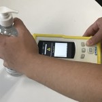 Figure 2 showing a TacticID handheld Raman analyzer scanning a bottle of hand sanitizer